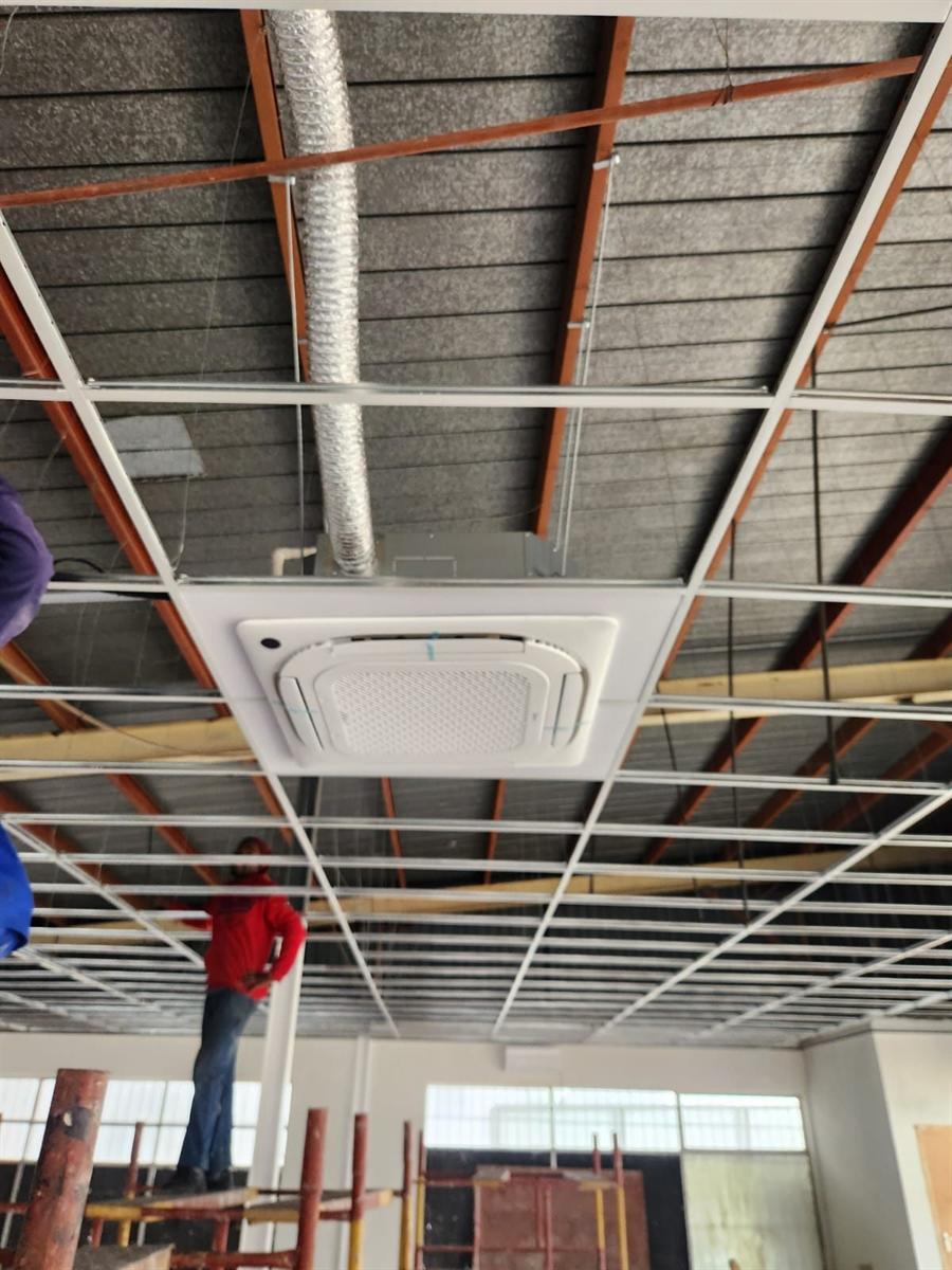Ceiling cassette air conditioner installed into a suspended ceiling grid