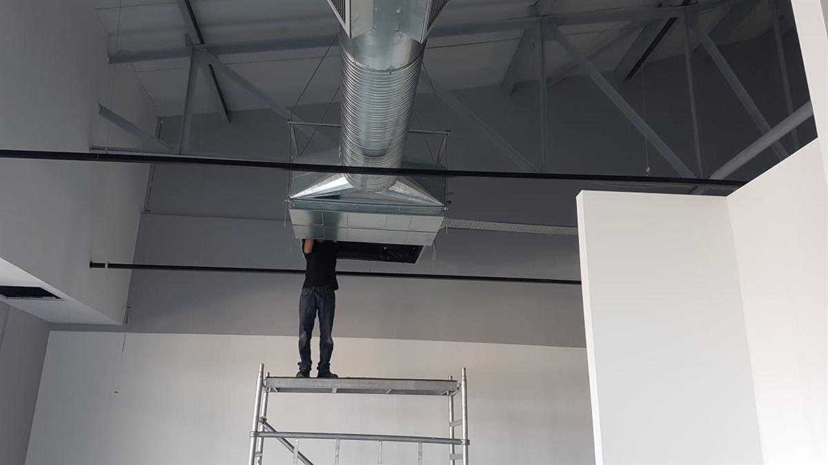Ducted indoor unit and plenum being installed in a retail ceiling