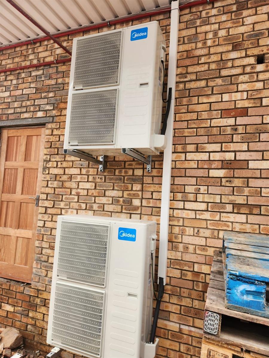 Midea split unit outdoor condensers with neat vertical trunking